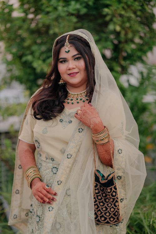 Free A woman in traditional South Asian attire poses outdoors with a smile. Stock Photo