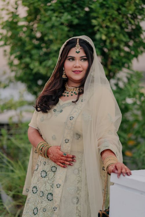 Free Portrait of a South Asian woman in traditional attire with intricate jewelry outdoors. Stock Photo