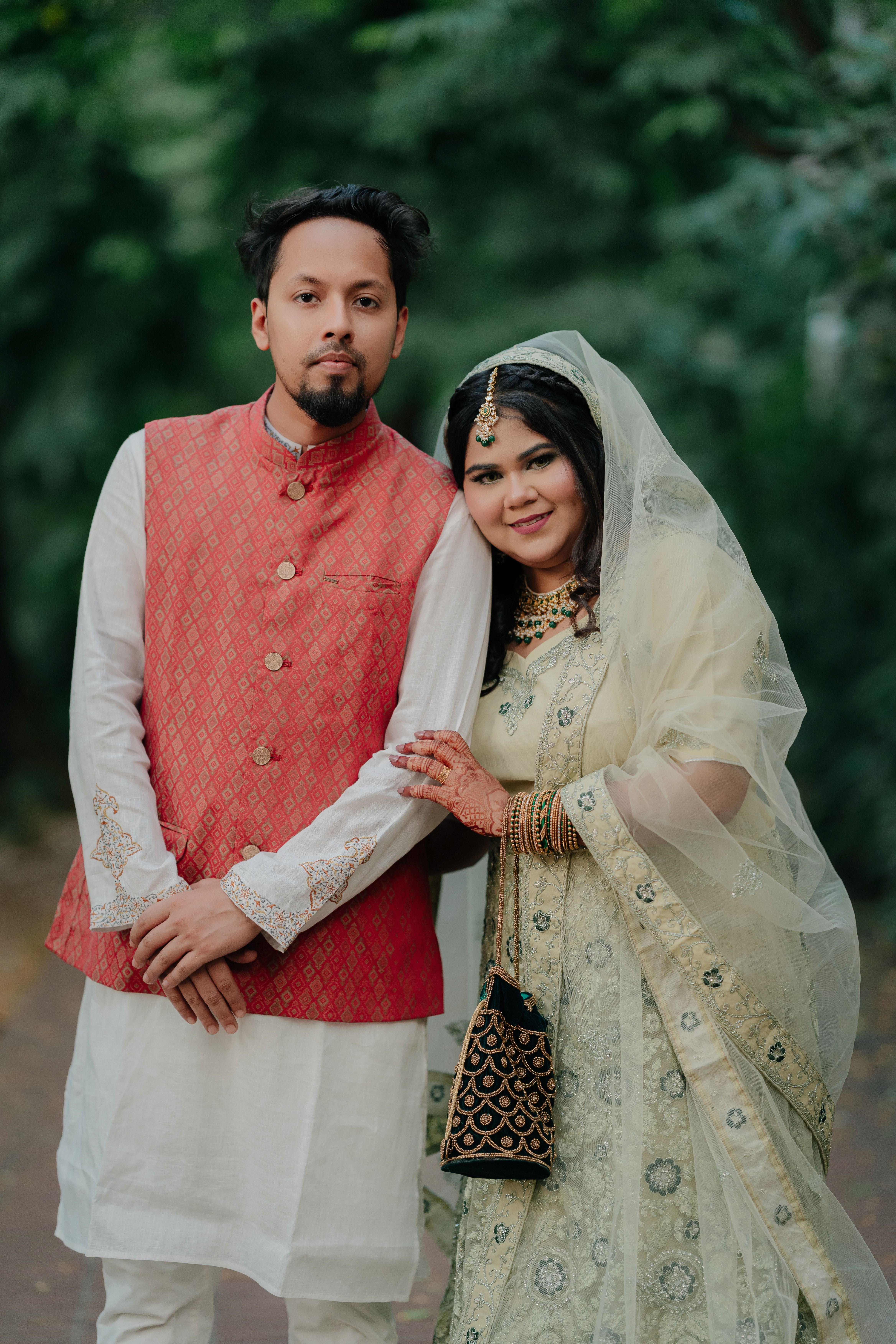Elegant Couple in Traditional Attire Pose Outdoors · Free Stock Photo