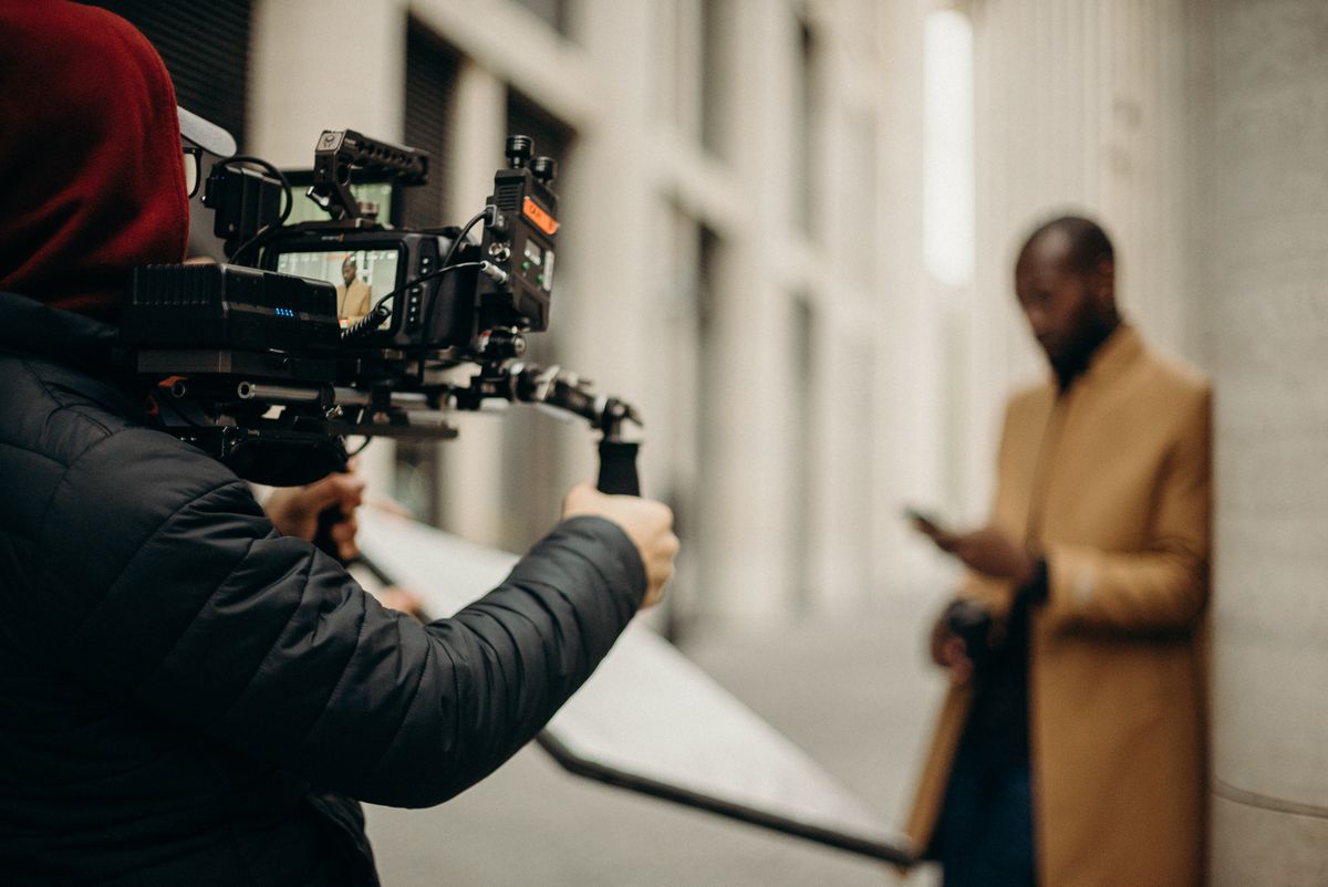 A professional creator being filmed with a camera rig