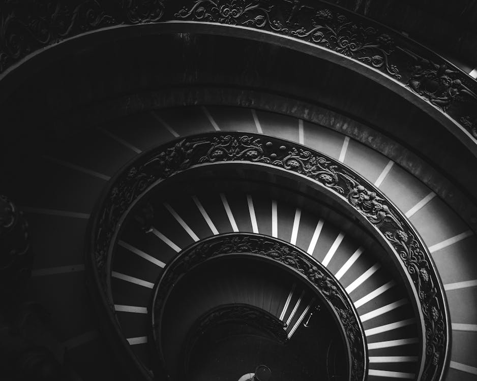 Grayscale Photography of Spiral Stairs