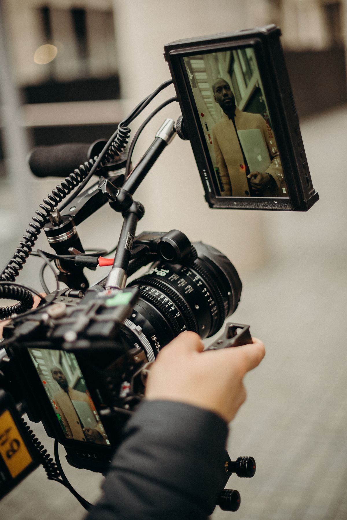 Videographer adjusting camera gear during a location shoot