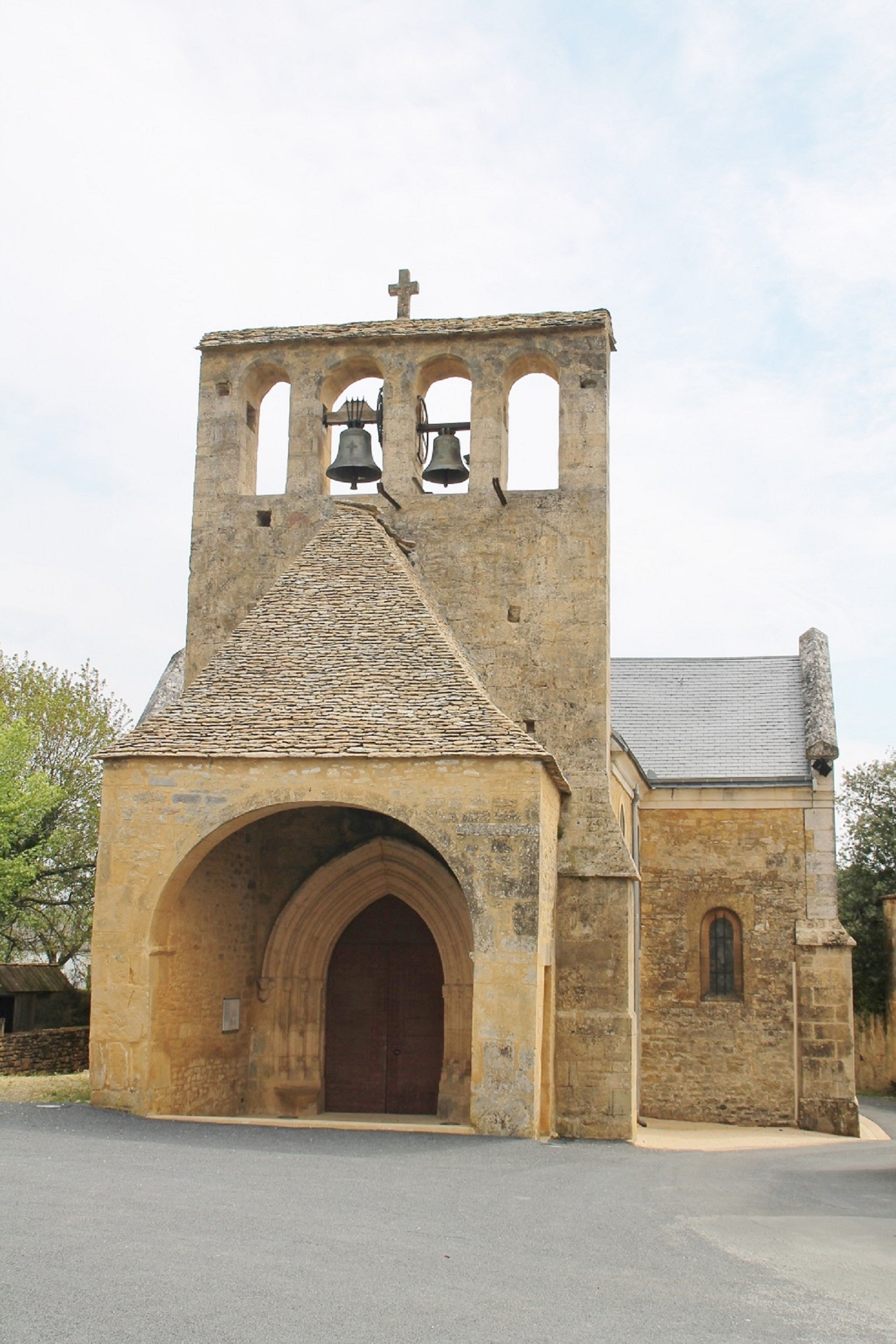 Medieval stone church with bell tower in Prats-de-Carlux, France.