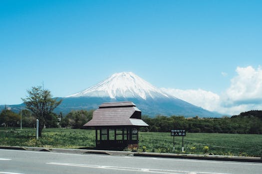 A stunning view of Mount Fuji with a traditional bus stop in Fujinomiya, Japan.