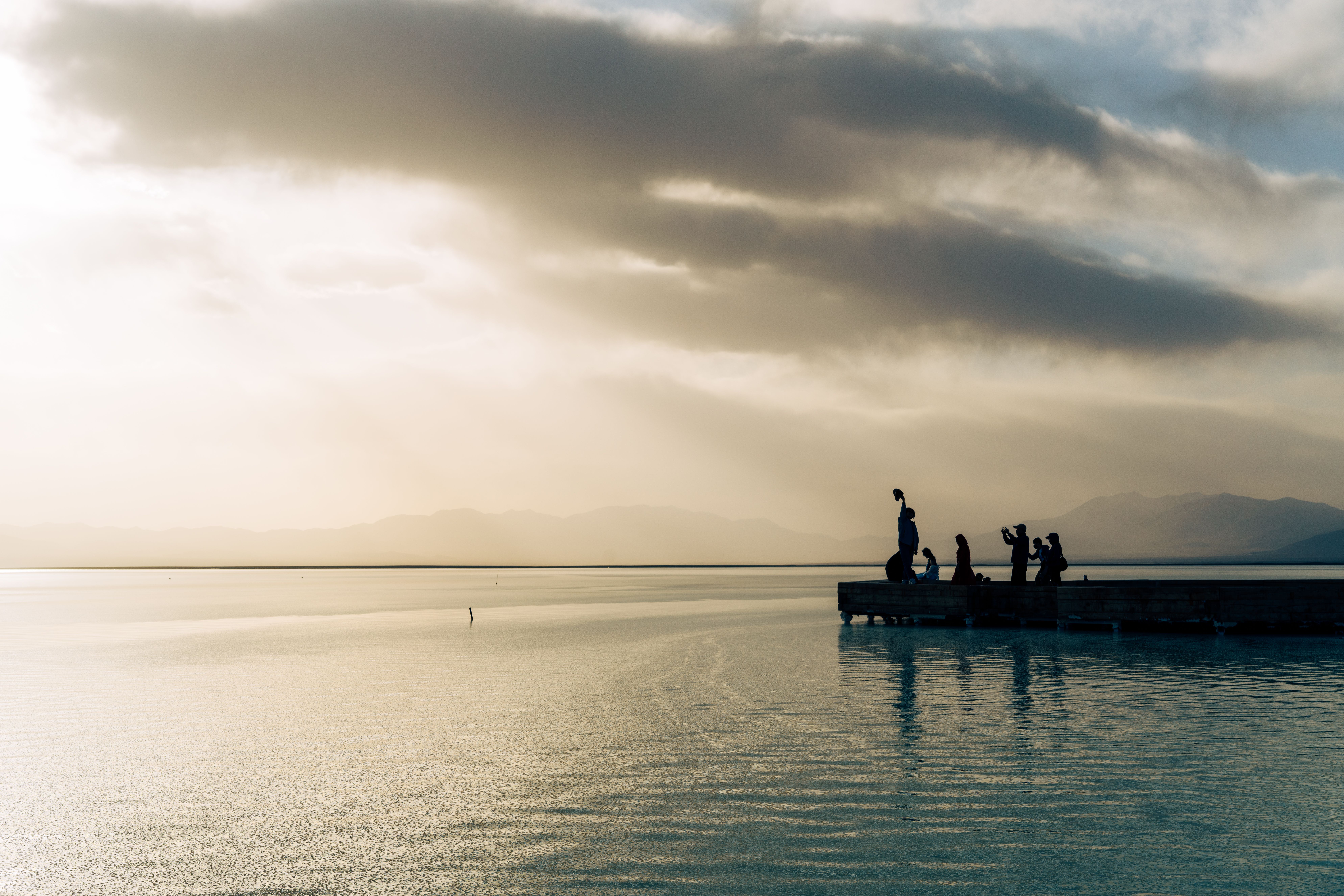 Silhouette of people enjoying dock at sunset, Djibouti