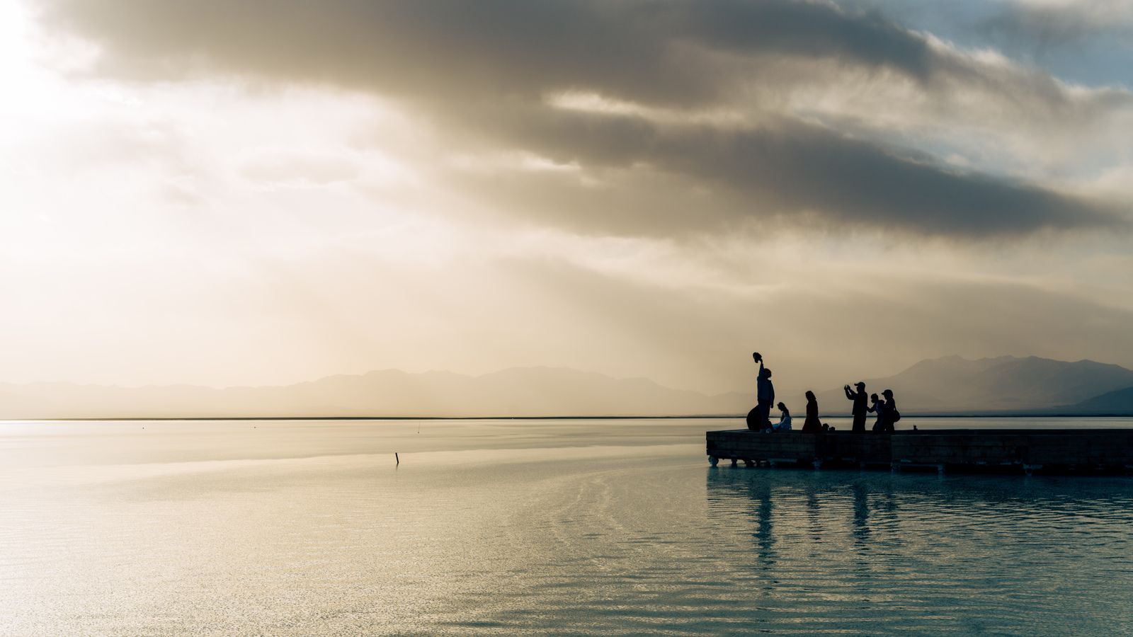 Silhouette of people enjoying dock at sunset, Djibouti