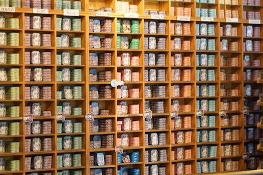 A vibrant arrangement of assorted canned goods on wooden shelves in a store.