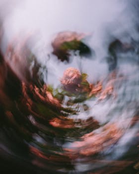 Abstract image capturing swirling pink blossoms with a vibrant and dreamy effect.