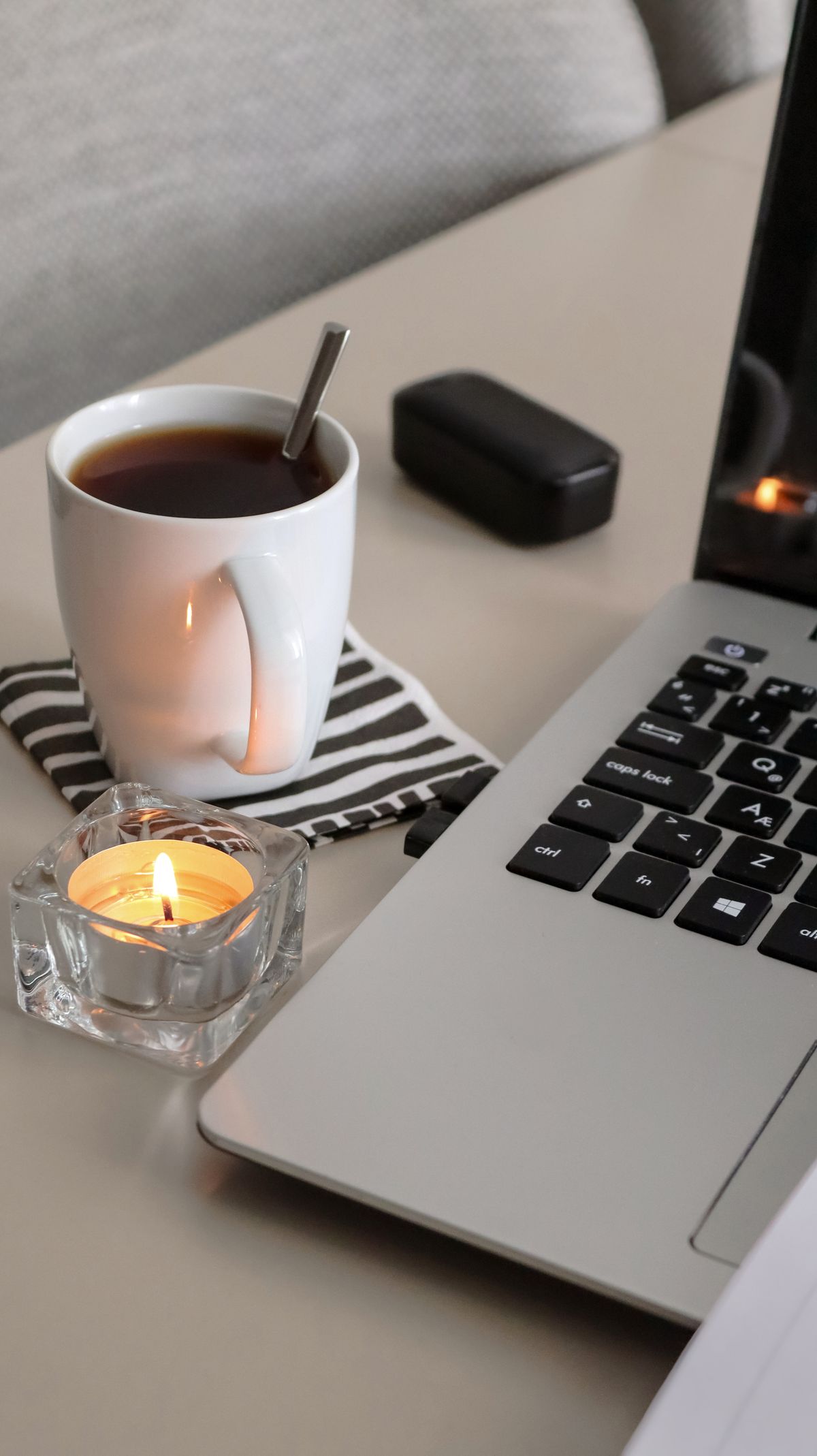 Một góc làm việc ấm cúng buổi tối với chiếc laptop và tách trà