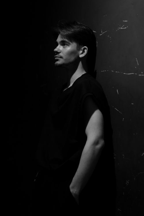 Free Artistic black and white portrait capturing the contemplative mood of a young man. Stock Photo