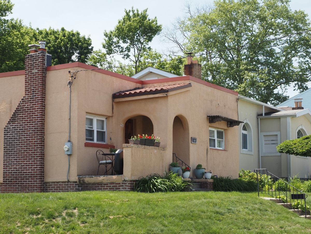 Charming mid-century suburban home with tree-lined walkway