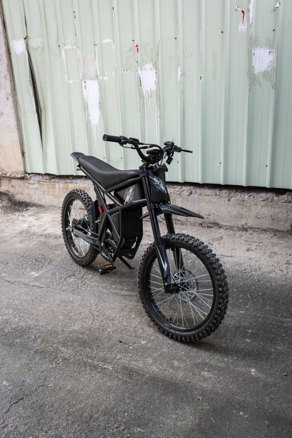 Blacked-out electric dirt bike front view