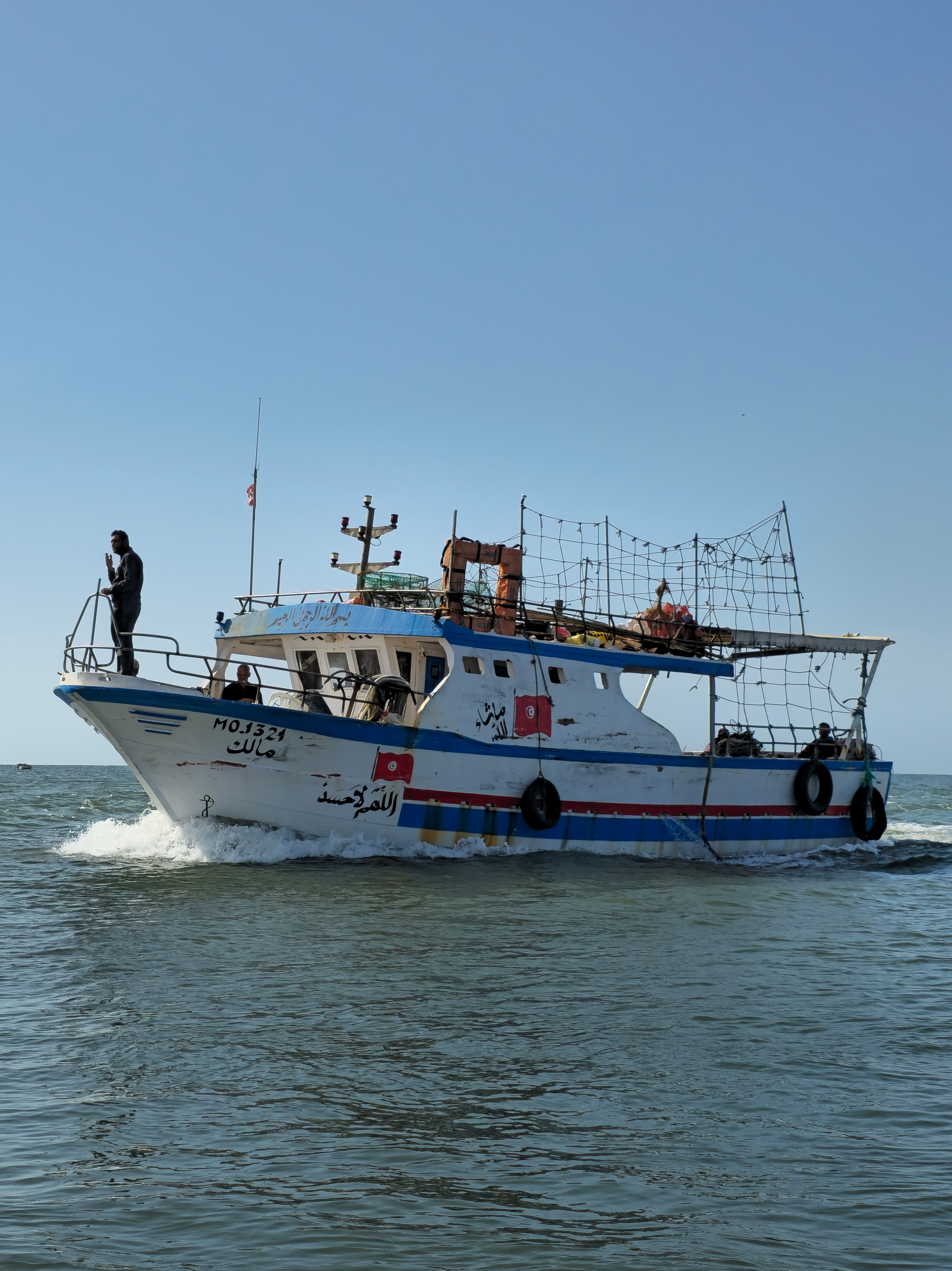 Fishing boat running across deep blue open ocean