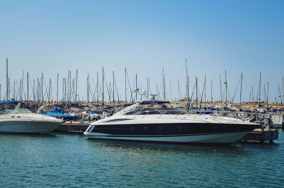 Unforgettable Dubai Marina Luxury Yacht Tour with Optional Breakfast or BBQ Review 2026 - A sleek luxury yacht docked at a sunny marina harbor on a clear day under blue skies.