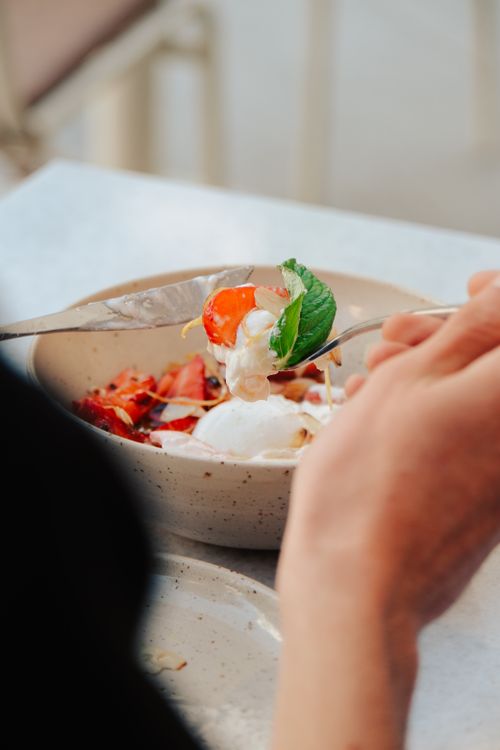 Free Close-up of fresh fruit and yogurt served in a ceramic bowl with a mint garnish. Stock Photo