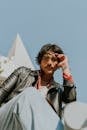 Stylish Young Man Posing Outdoors in Sunlight