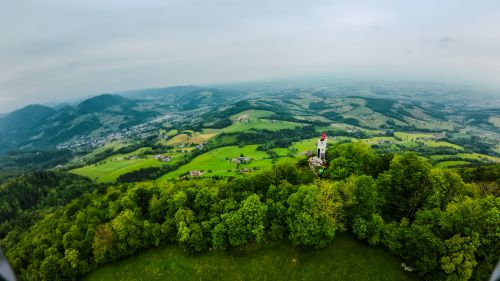 Free Breathtaking aerial view of lush green landscapes and a historic tower in Scheibbs, Austria. Stock Photo
