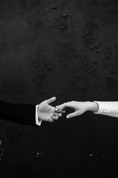Artistic black and white photo of two hands reaching out, symbolizing connection and longing.