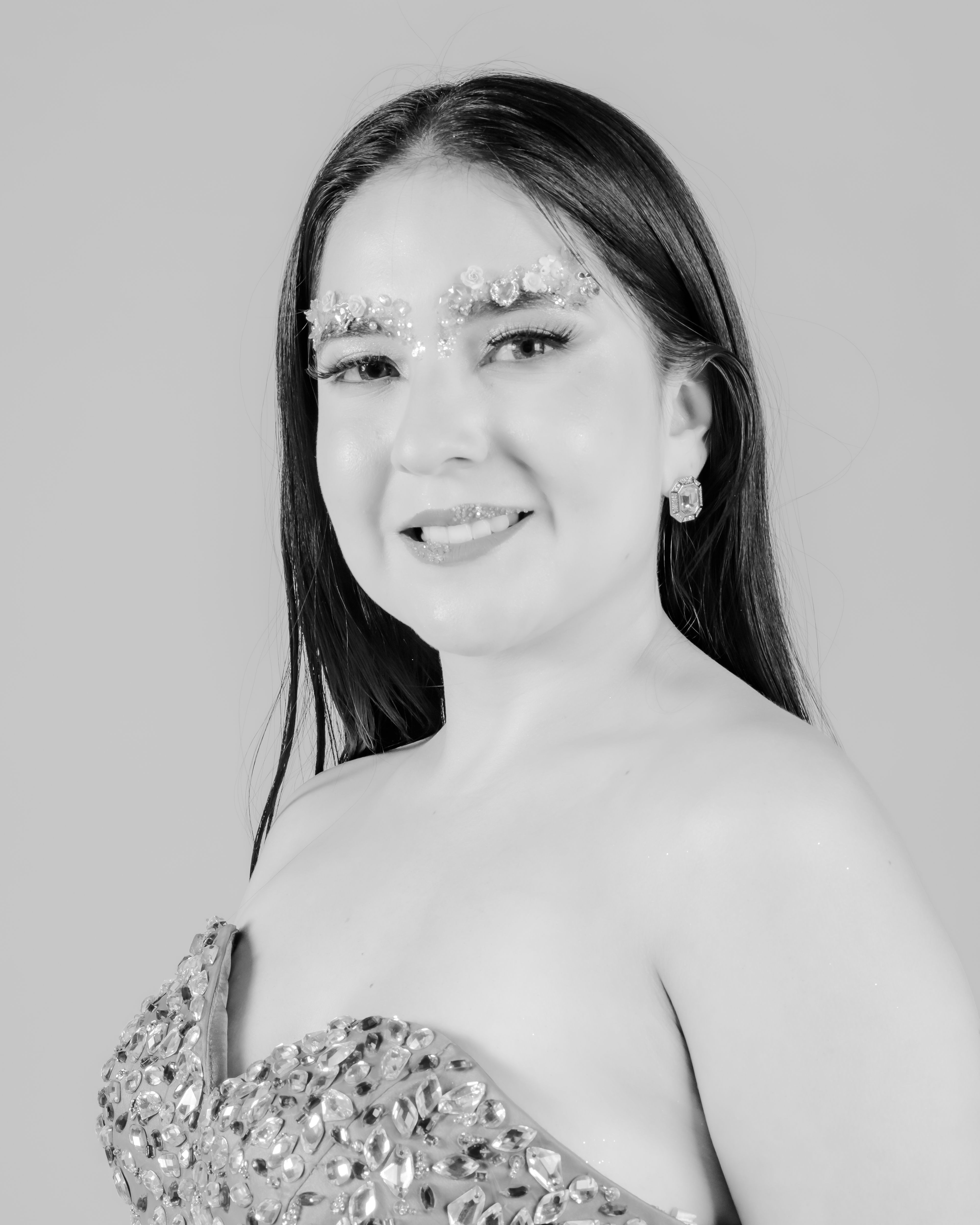 Portrait of a woman with decorative eyebrows and elegant dress, exuding confidence and grace.