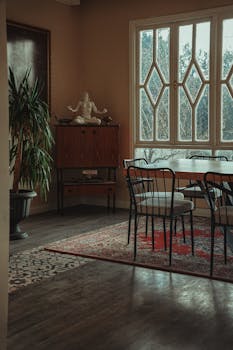 Sunlit dining room with vintage decor and elegant furnishings.