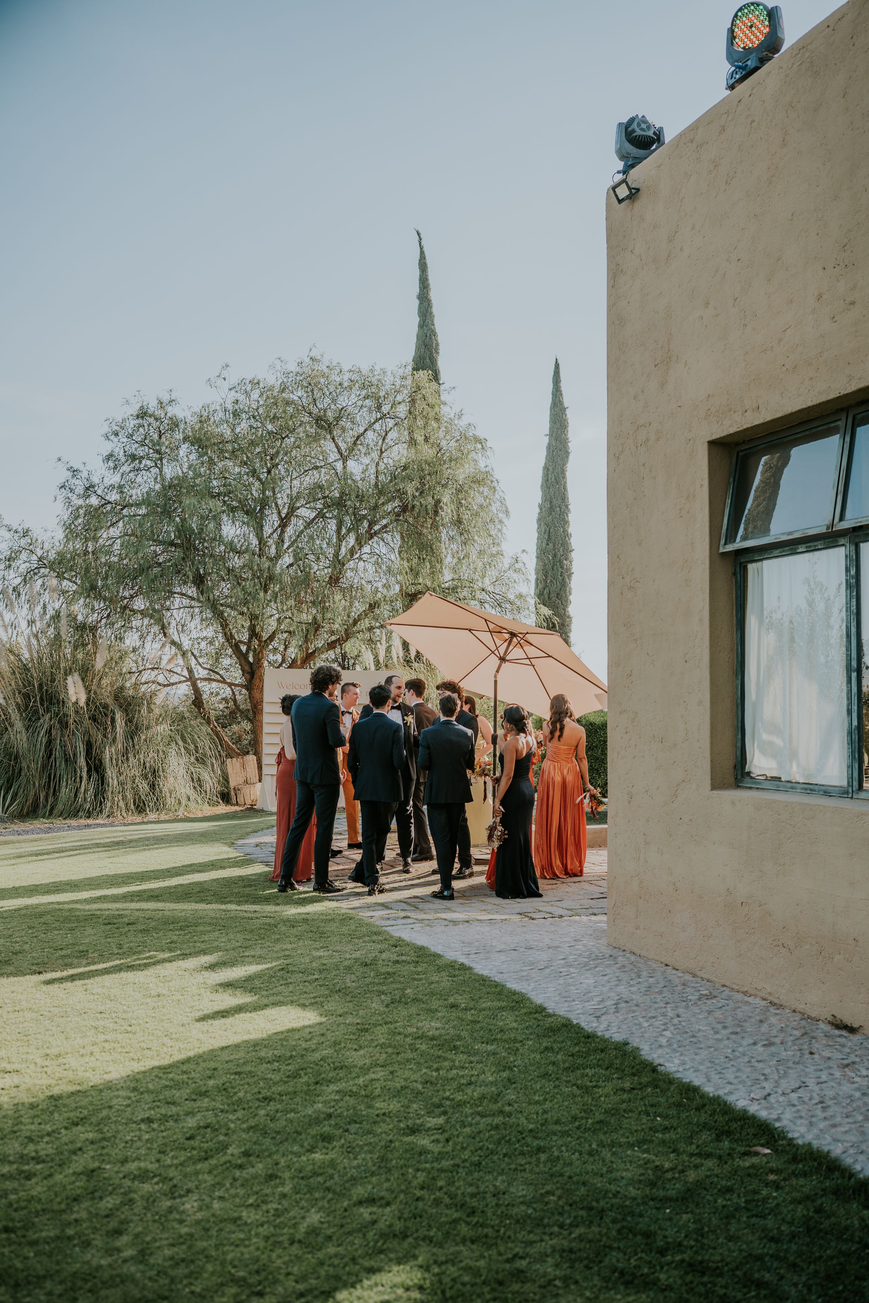 Wedding guests in elegant fall outfits celebrating at an outdoor autumn wedding