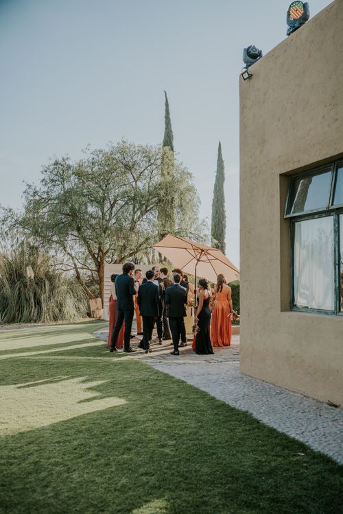 Wedding guests in elegant fall outfits celebrating at an outdoor autumn wedding
