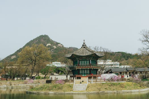 A serene view of a traditional Korean pavilion amidst cherry blossoms in Seoul.
