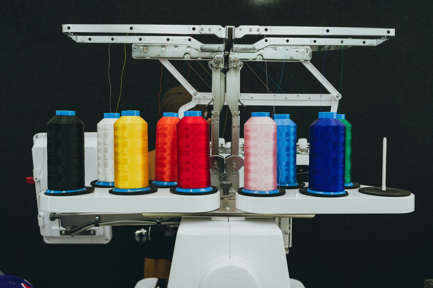 Colorful thread spools on an industrial embroidery machine