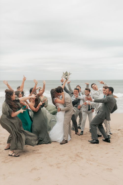 Free Group of friends celebrating a wedding on a sandy beach, capturing happiness and love. Stock Photo