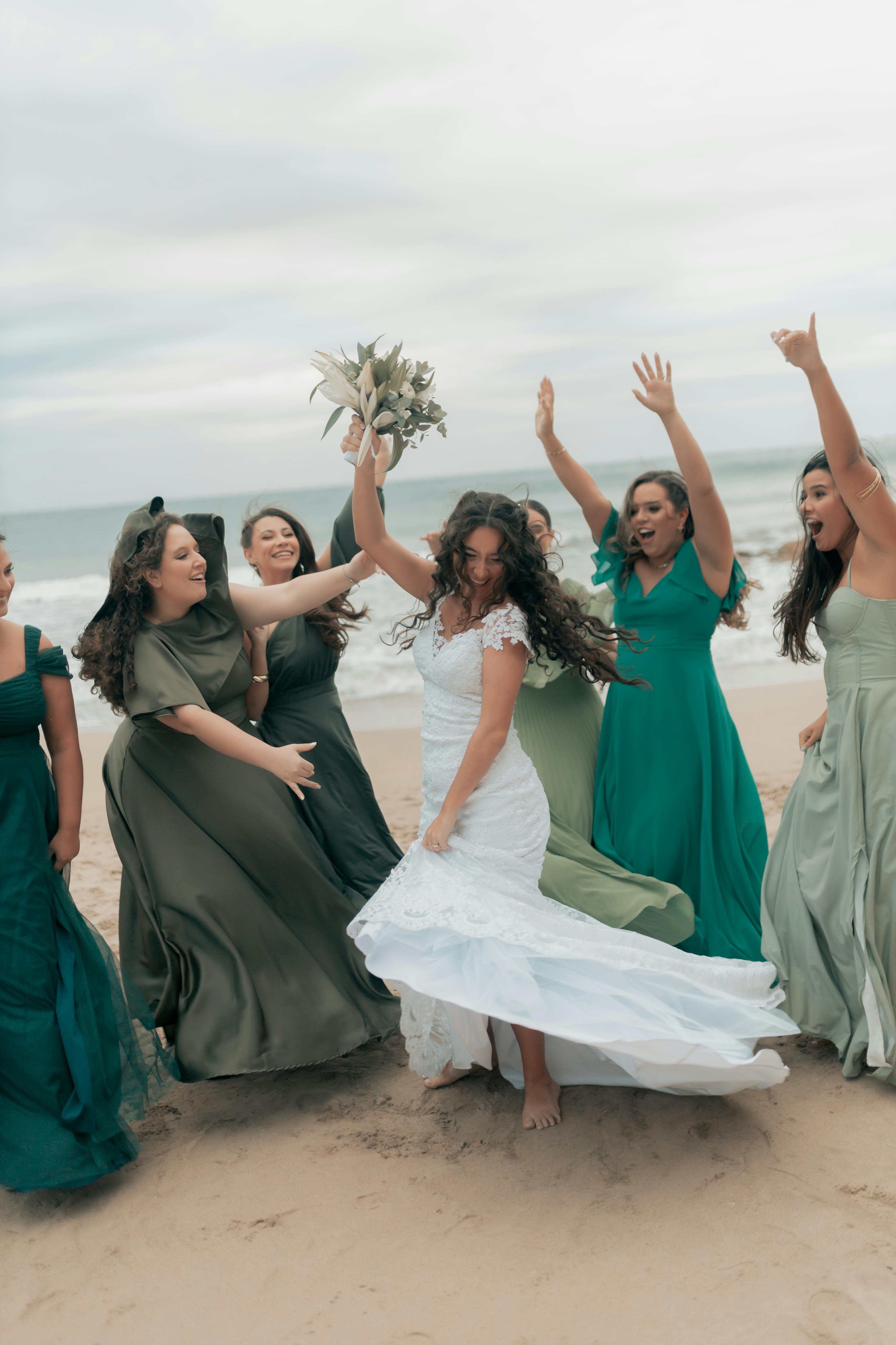 Joyful Beach Wedding Celebration with Bridesmaids · Free Stock Photo