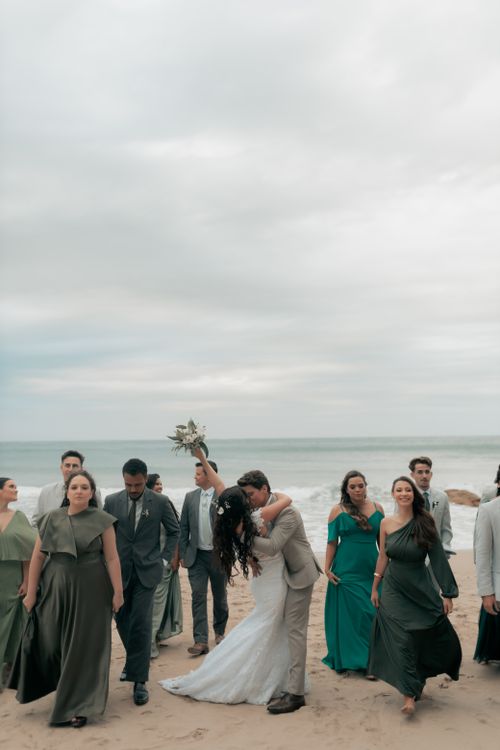 Free Couple and friends celebrate a beach wedding with joy and elegance. Stock Photo