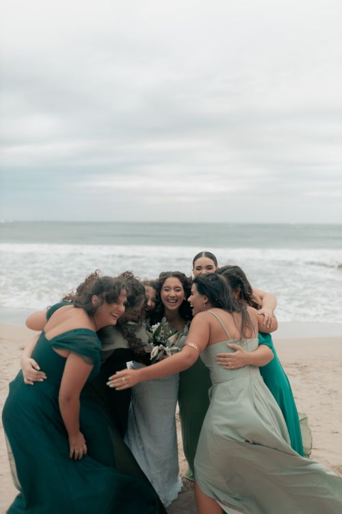 Free A group of women celebrating at a beach wedding, showcasing happiness and togetherness. Stock Photo