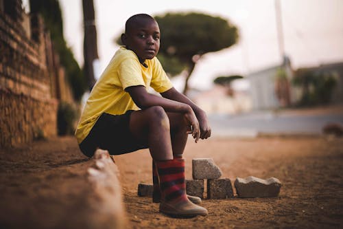 Free Boy Wearing Yellow Crew-neck Shirt and Black Short Stock Photo