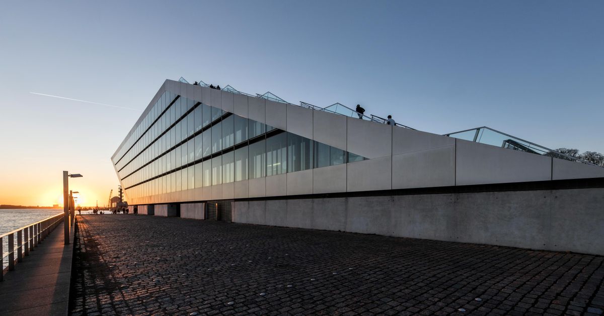 Capture of modern architecture in Hamburg at sunset, showcasing futuristic design and cityscape.