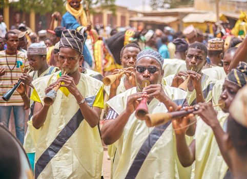 Group of traditional musicians performing at a vibrant Nigerian festival.