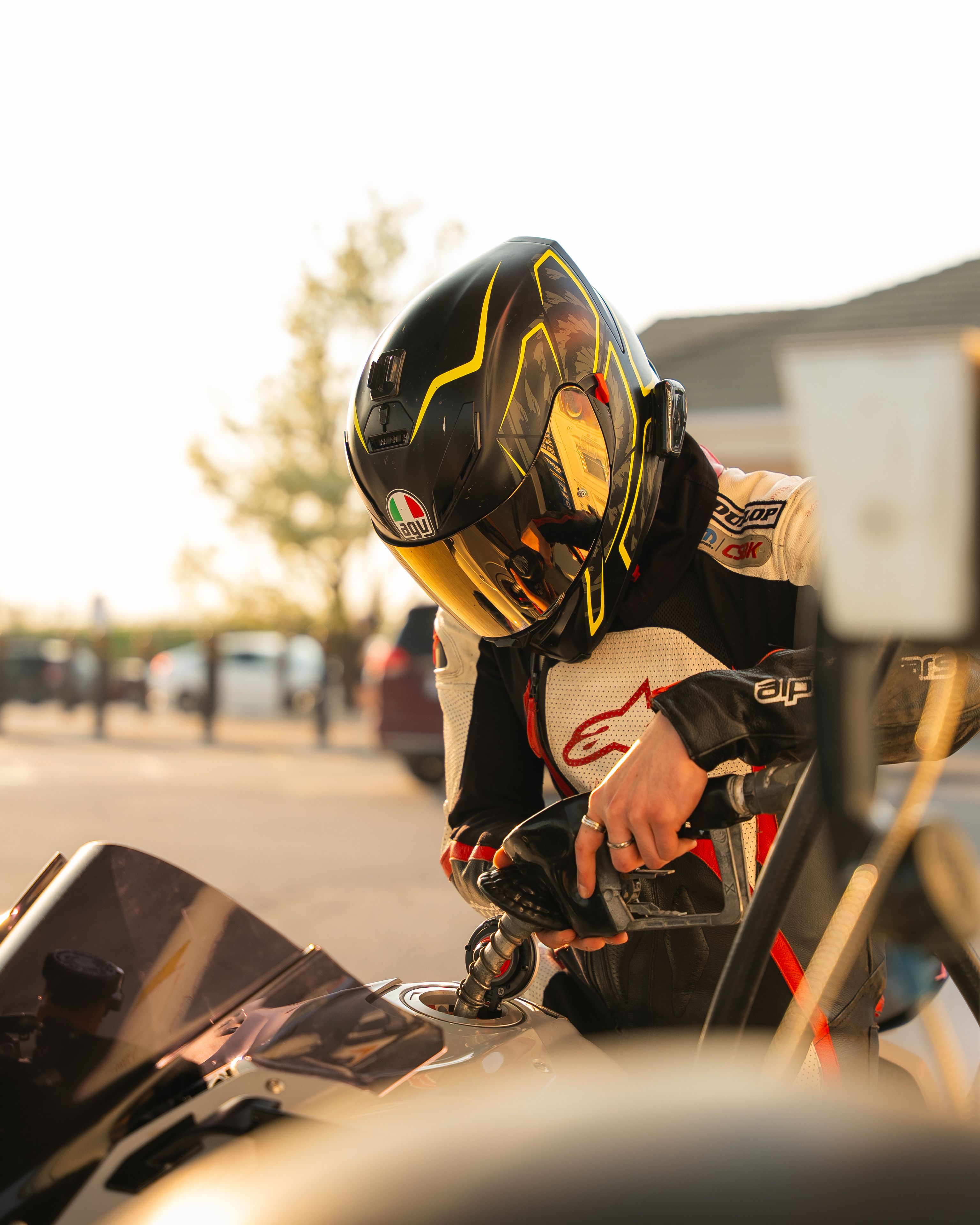 Professional Racer Refuels Motorcycle during Daylight · Free Stock Photo
