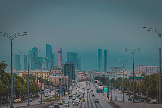 Dynamic view of Moscow City skyline with busy urban traffic and skyscrapers at dusk.