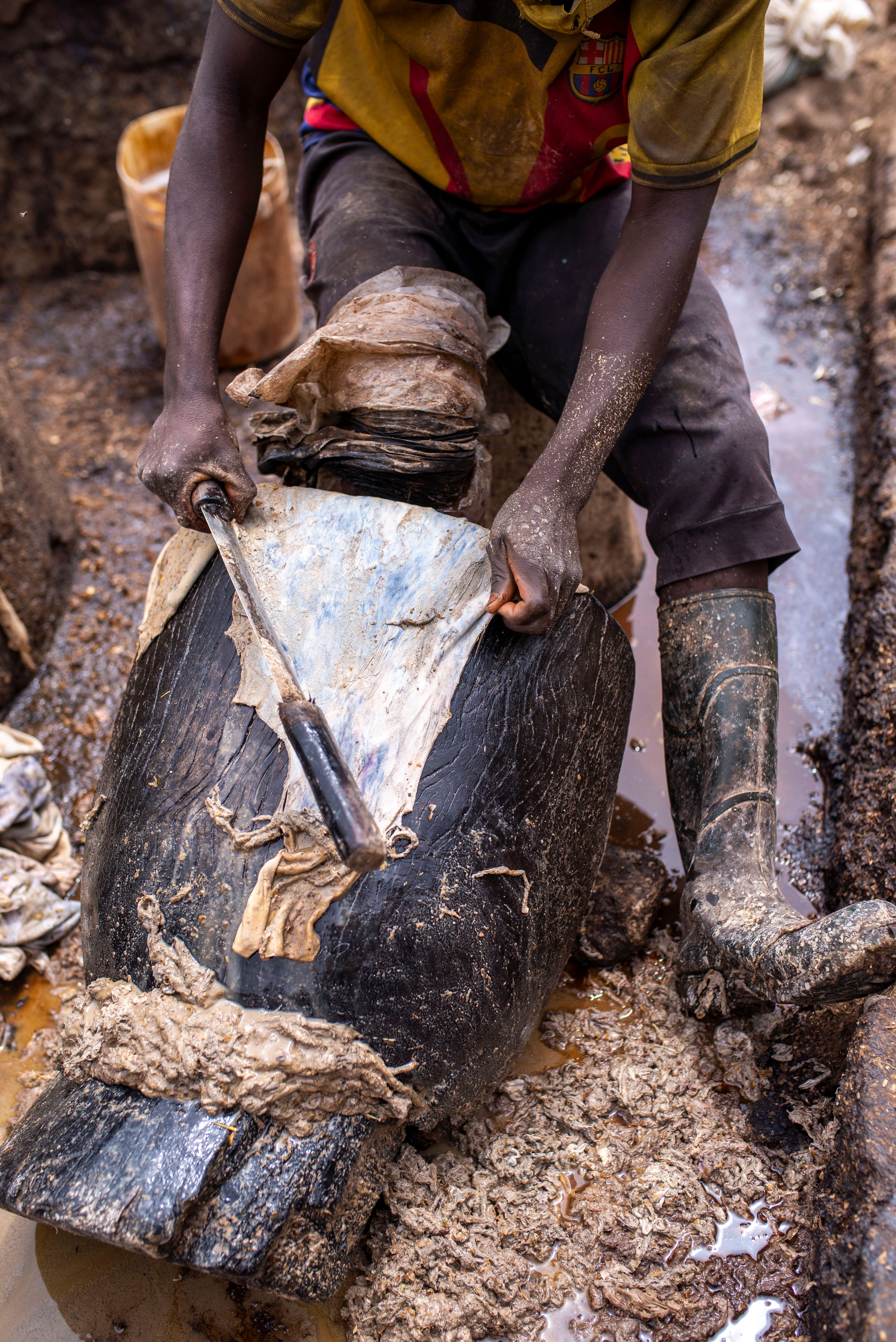 Leather Worker Tannin Process in Muddy Setting · Free Stock Photo