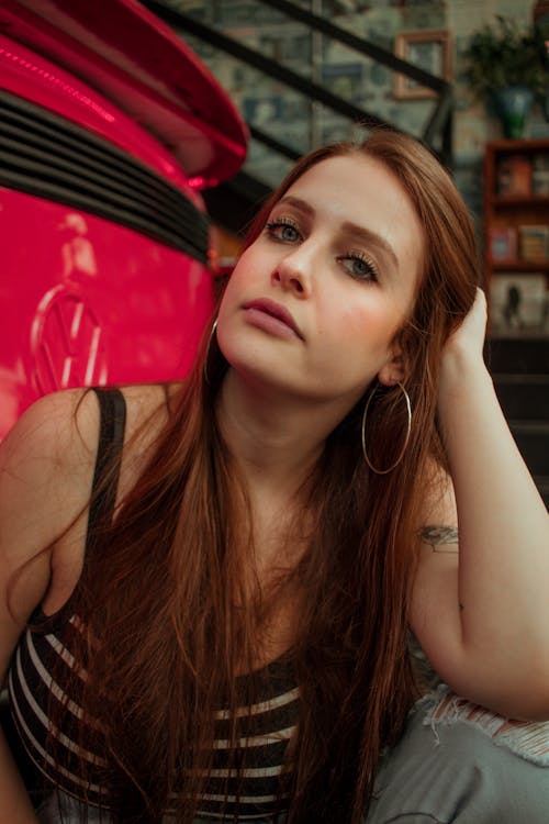 Free Woman Wearing Black and White Striped Tank Top Touching Her Stock Photo