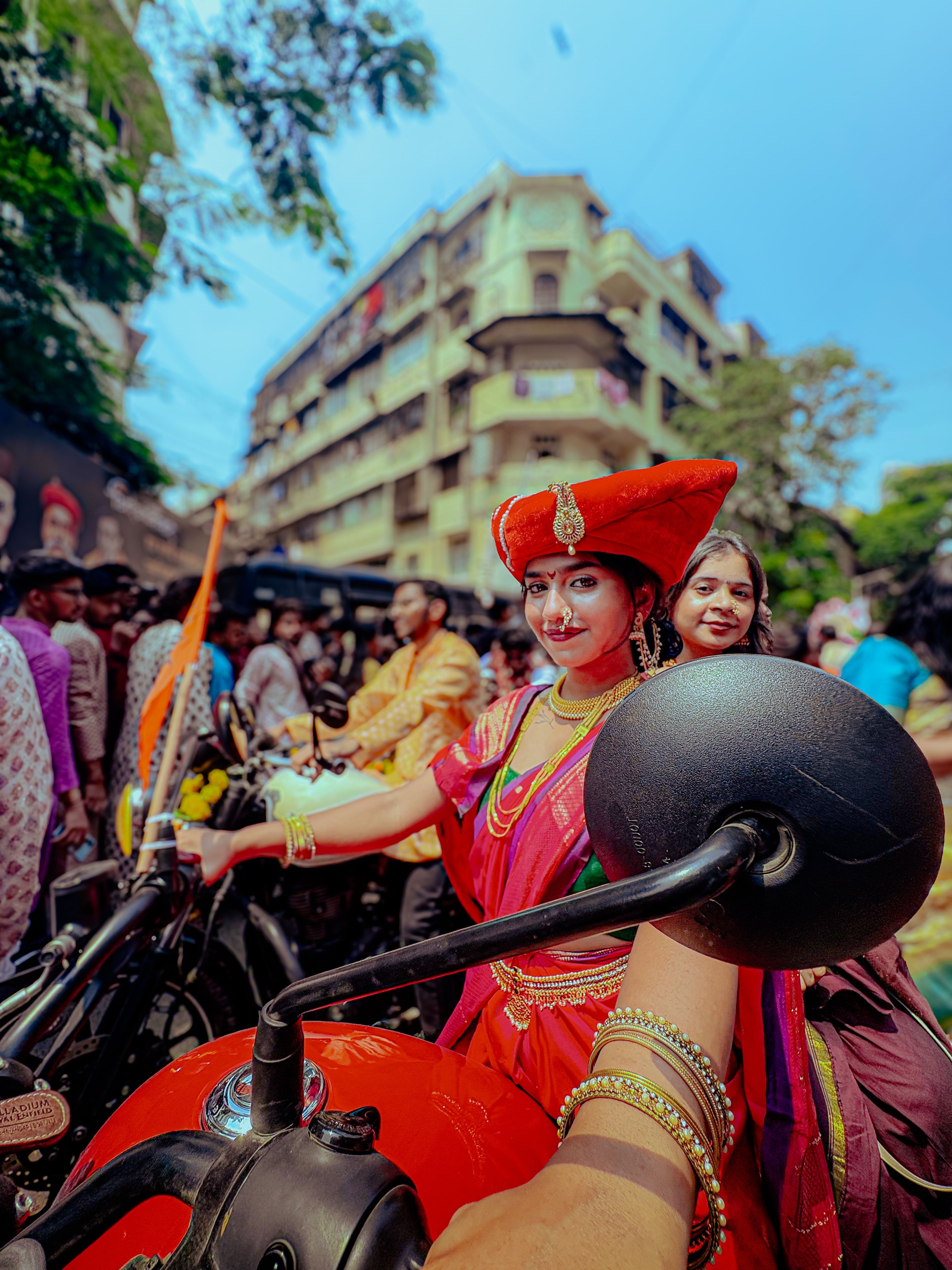 Woman in traditional attire celebrating Gudi Padwa on city street.