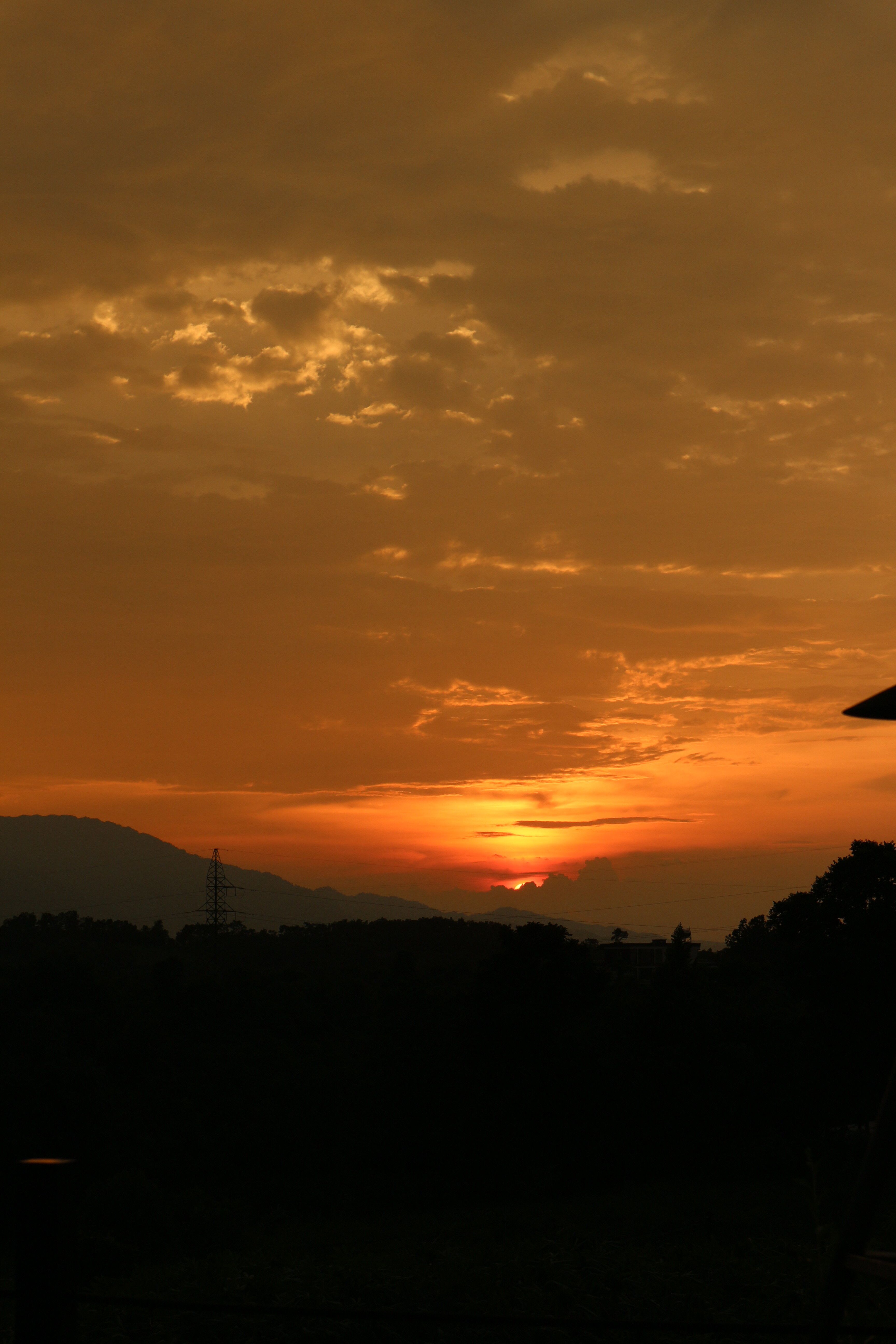Stunning Orange Hued Sunset Over Mountains · Free Stock Photo