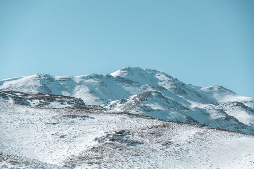 Free Stunning snow-covered mountain landscape in Qom, Iran, under a clear blue sky. Stock Photo