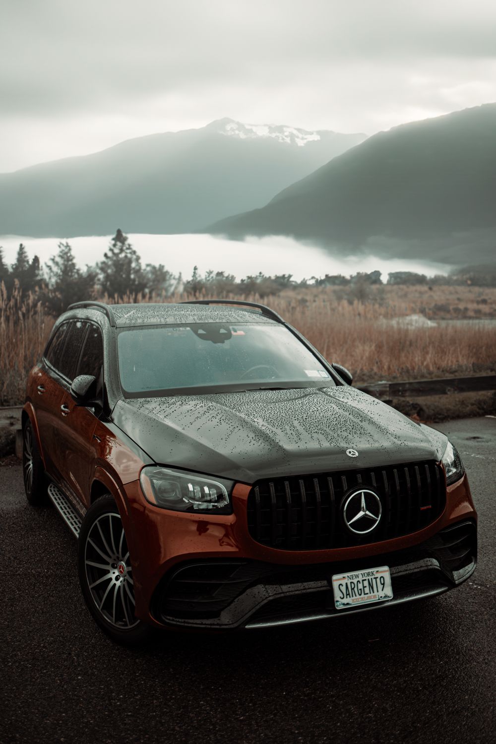Luxury SUV parked in a mountain landscape