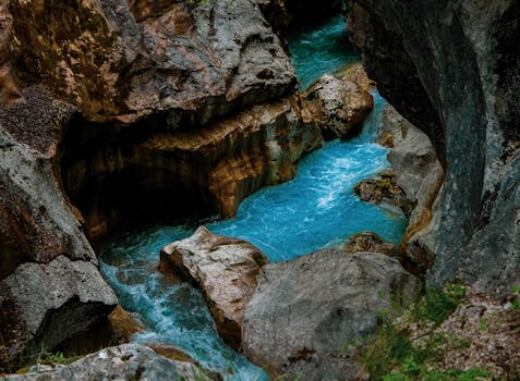 Stunning capture of the Soča River's turquoise waters flowing through the Tolmin Gorge in Slovenia.