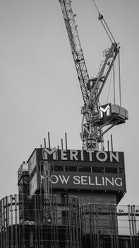 High-rise construction crane at Meriton building site, black and white photo.