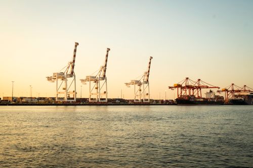 Free Sunset view of cranes and container ships at Fremantle Port, Western Australia. Stock Photo