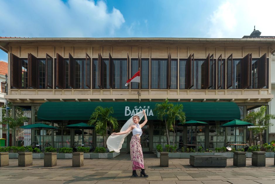 A cozy cafe in Jakarta, Indonesia, with a prominent 'Free Wi-Fi' sign