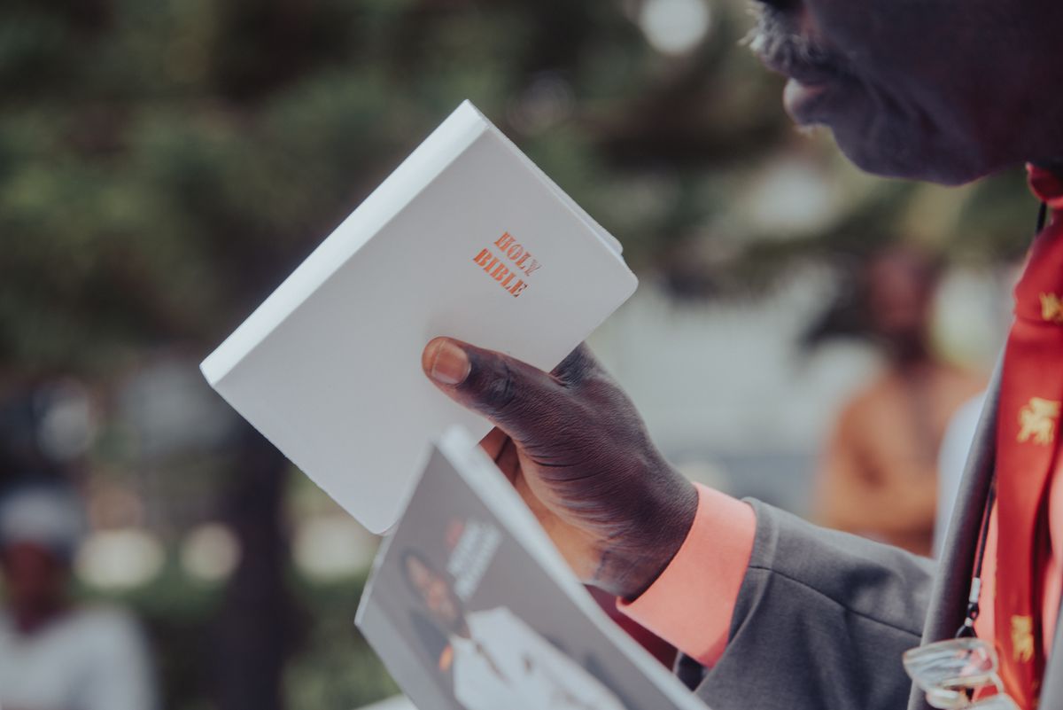 African man holding a Holy Bible