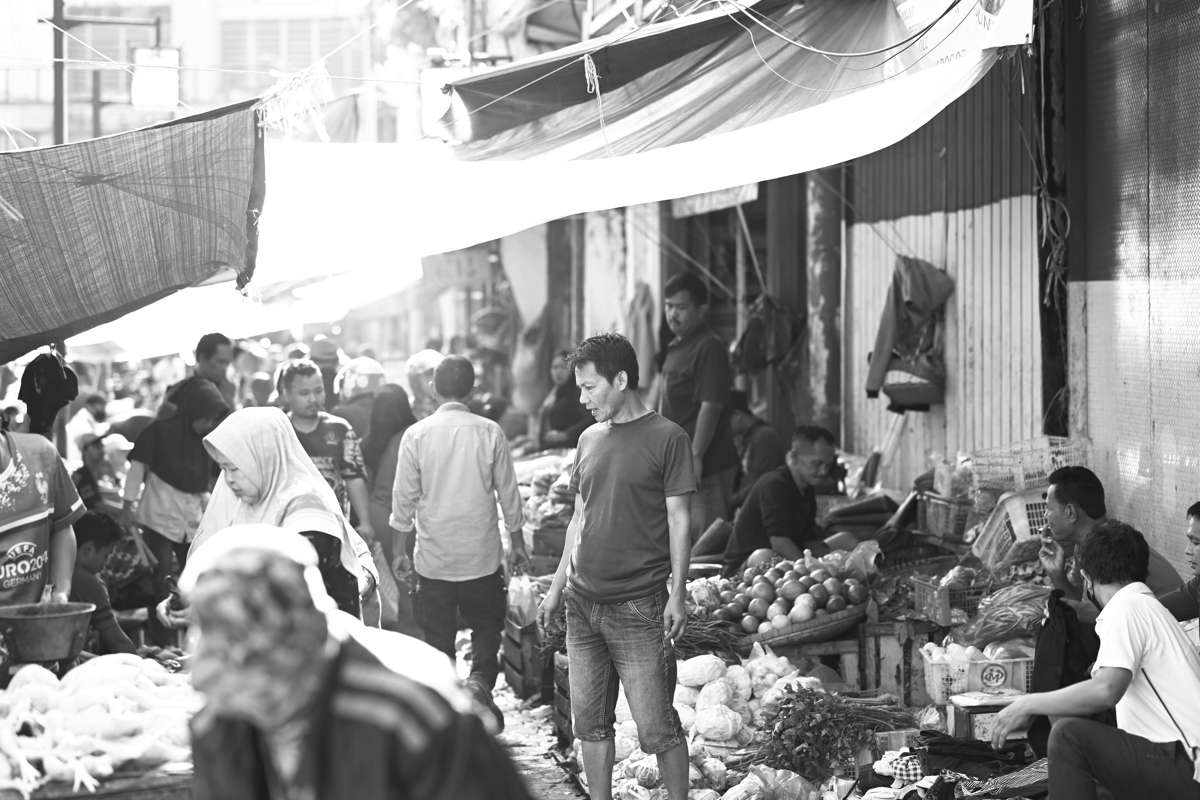 Bustling street market in Bogor, West Java, showcasing diverse local produce and vibrant community life in black and white.