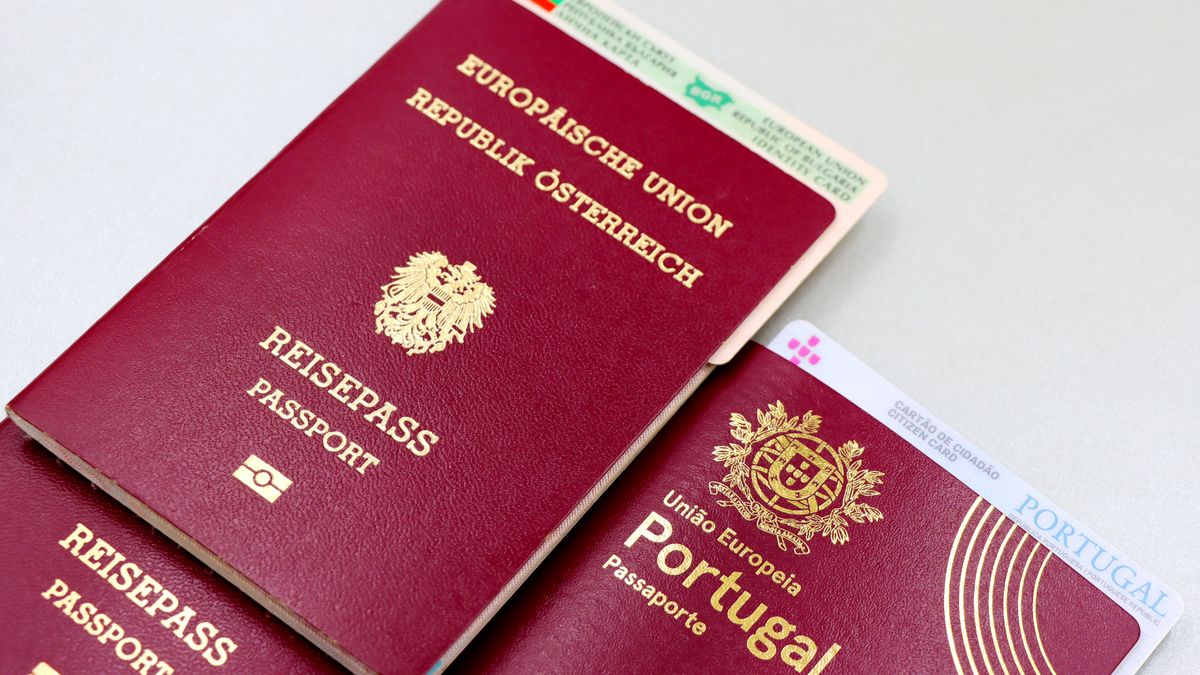 A close-up image of Austrian and Portuguese passports with a Bulgarian ID card.